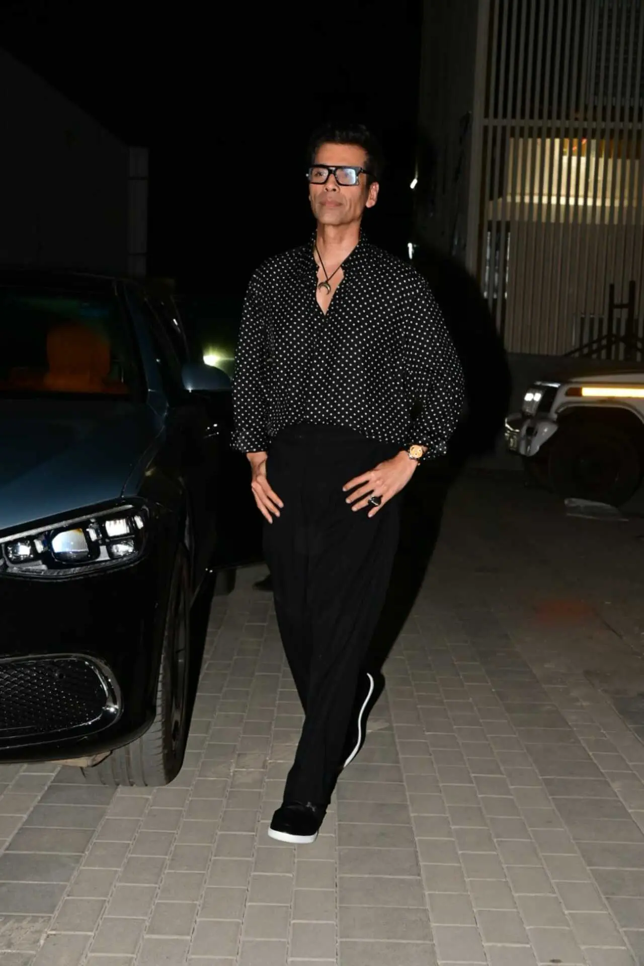 Karan Johar turned heads in a black polka-dot shirt paired with sleek black trousers during his latest outing. Karan Johar turned heads in a black polka-dot shirt paired with sleek black trousers during his latest outing.
